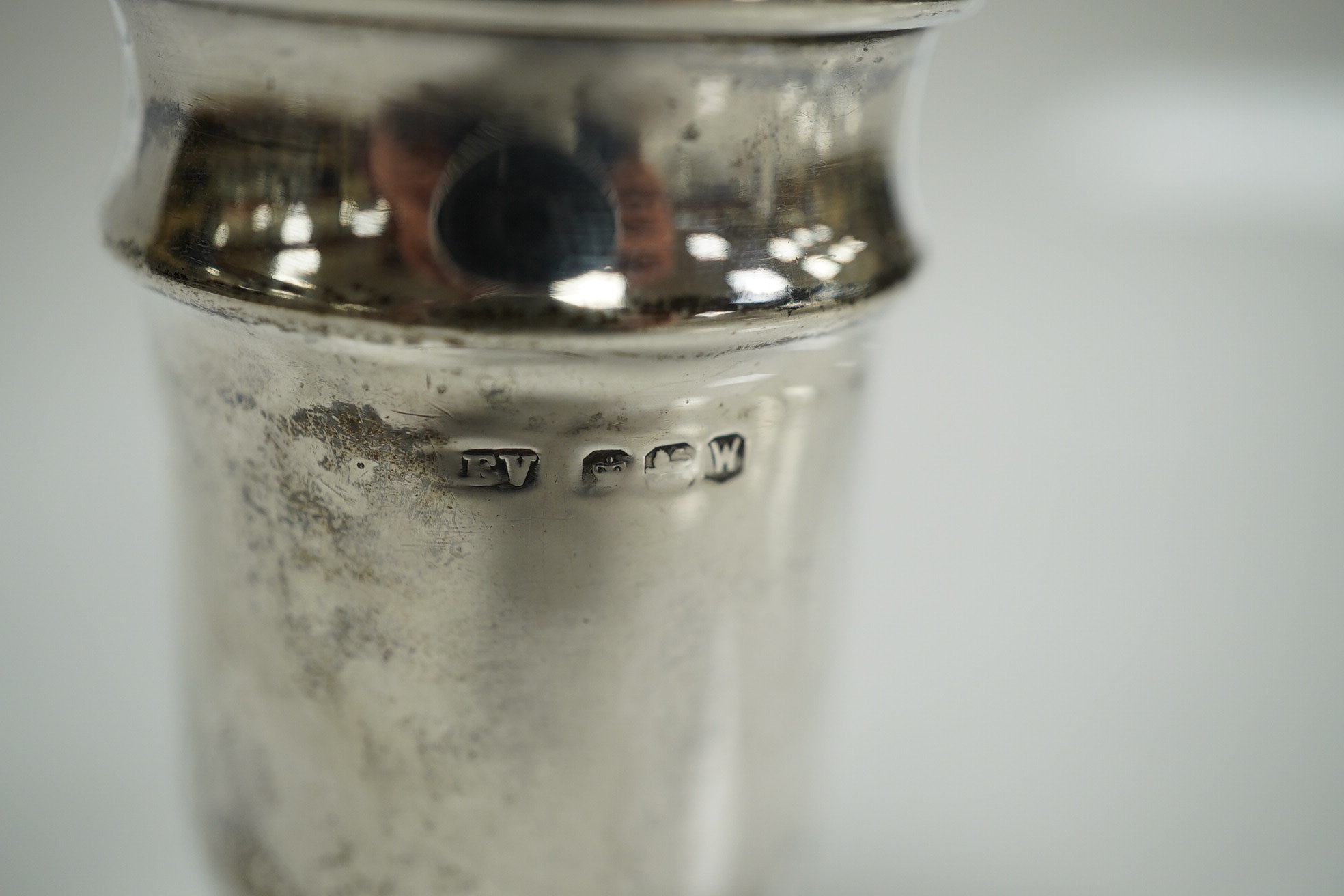 An Elizabeth II silver three piece condiment set, Sheffield, 1964, six assorted silver napkin rings and a stylish Austro Hungarian white metal pill box, by George Adam Scheid, 62mm. Condition - fair